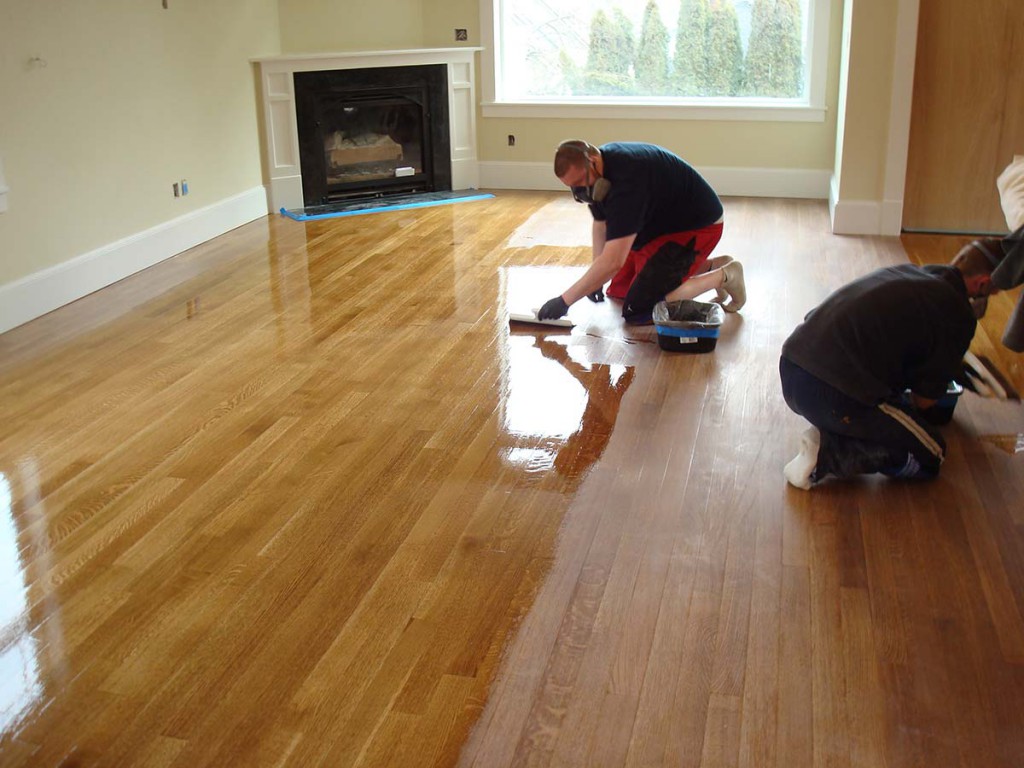 Flooring contractors finishing a wood flooring installation project