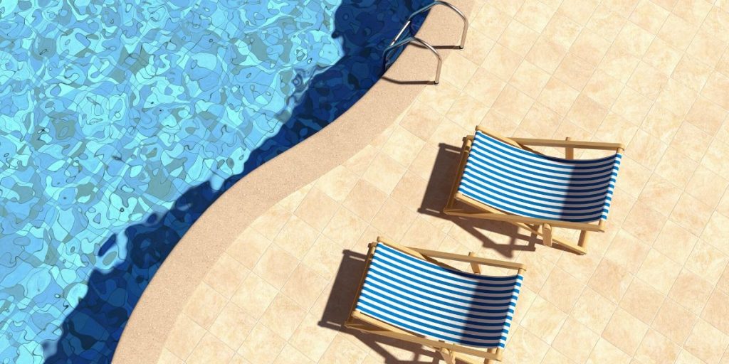 Natural Stone Outdoor Flooring by a Shimmering Swimming Pool