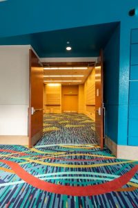 Luxury patterned carpet changing through a doorway
