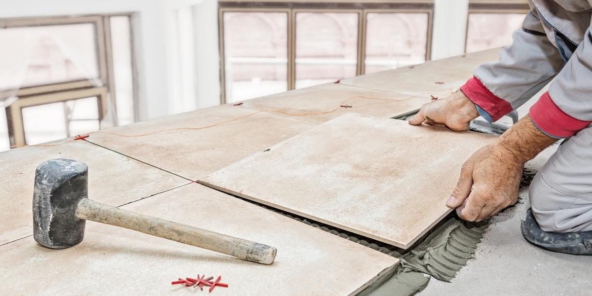 A flooring installer working on a South Florida home floor renovation project