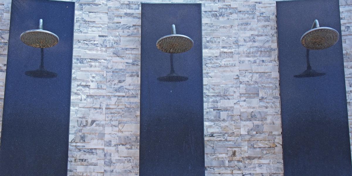 An outdoor shower featuring stone