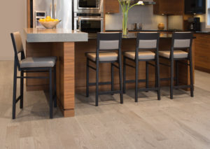 A modern kitchen with Mirage Hardwood Flooring and bar stools