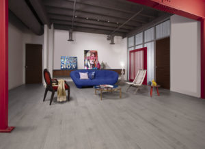 A living room with a blue couch and red walls featuring the Imagine Collection by Mirage Flooring