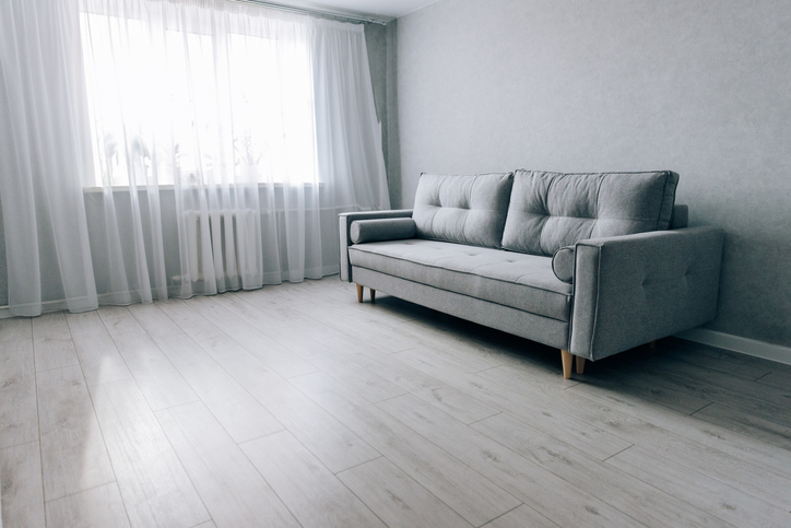 A living room remodeled with gray vinyl flooring.