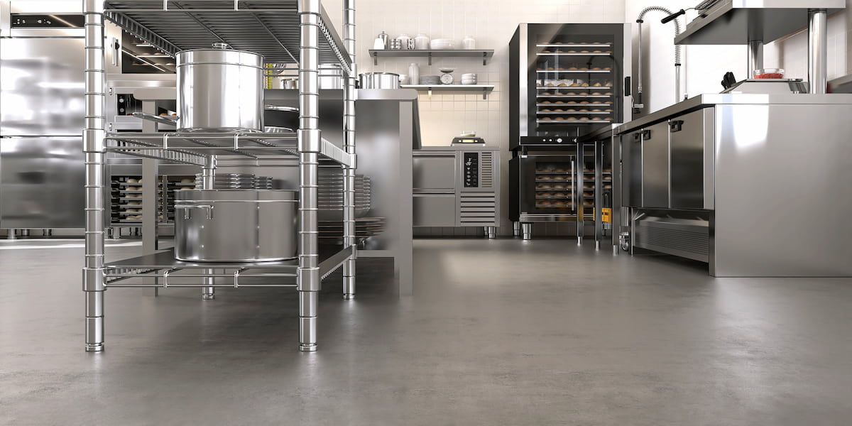 Modern commercial kitchen with durable flooring, illustrating the best flooring for commercial kitchen environments to ensure safety and efficiency.