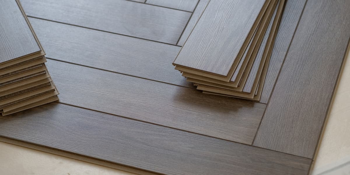 Stacked planks on a wood look surface representing low voc flooring materials used for cleaner indoor air quality