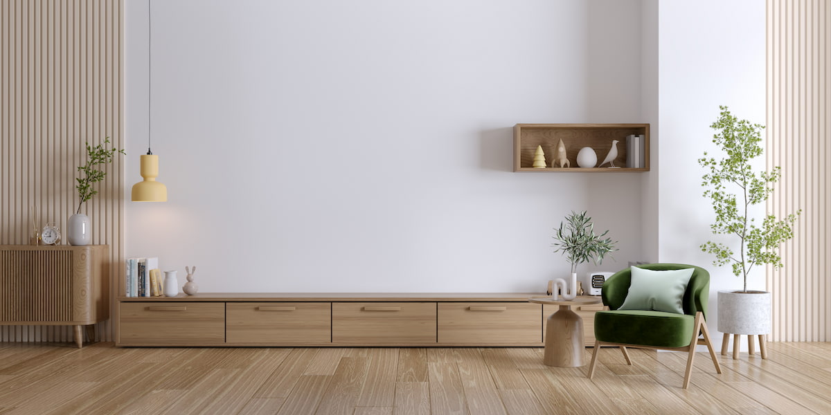 A modern living room with light-toned best engineered hardwood flooring, featuring stylish wood furniture, green accents, and a minimalist design.