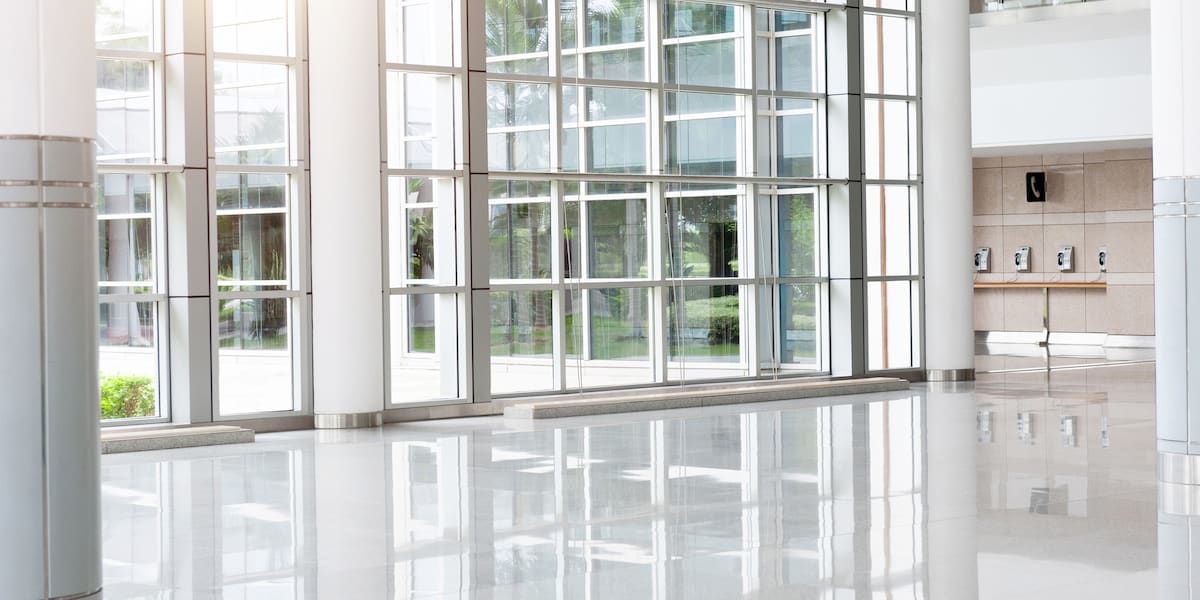 A hospital hallway with bright lighting and smooth, durable surfaces, highlighting hospital tile floor used in healthcare facilities.