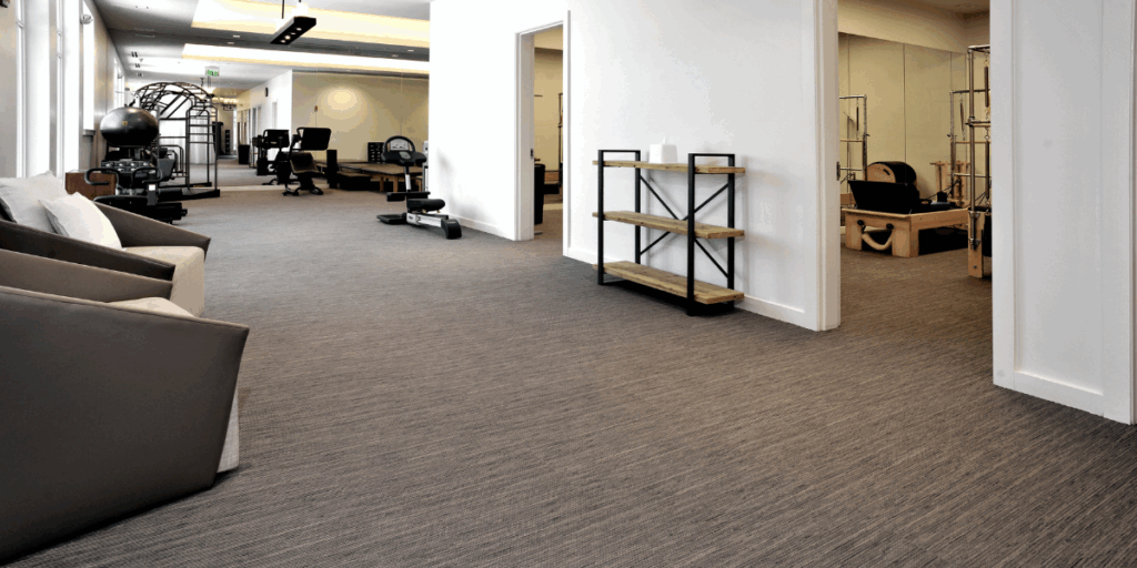 Commercial carpet flooring installation in a fitness and wellness facility designed for comfort, acoustics, and durability