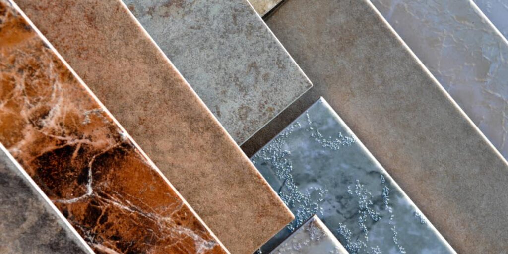 Assorted commercial-grade tile samples showing surface textures and finishes in compliance with tcna installation standards